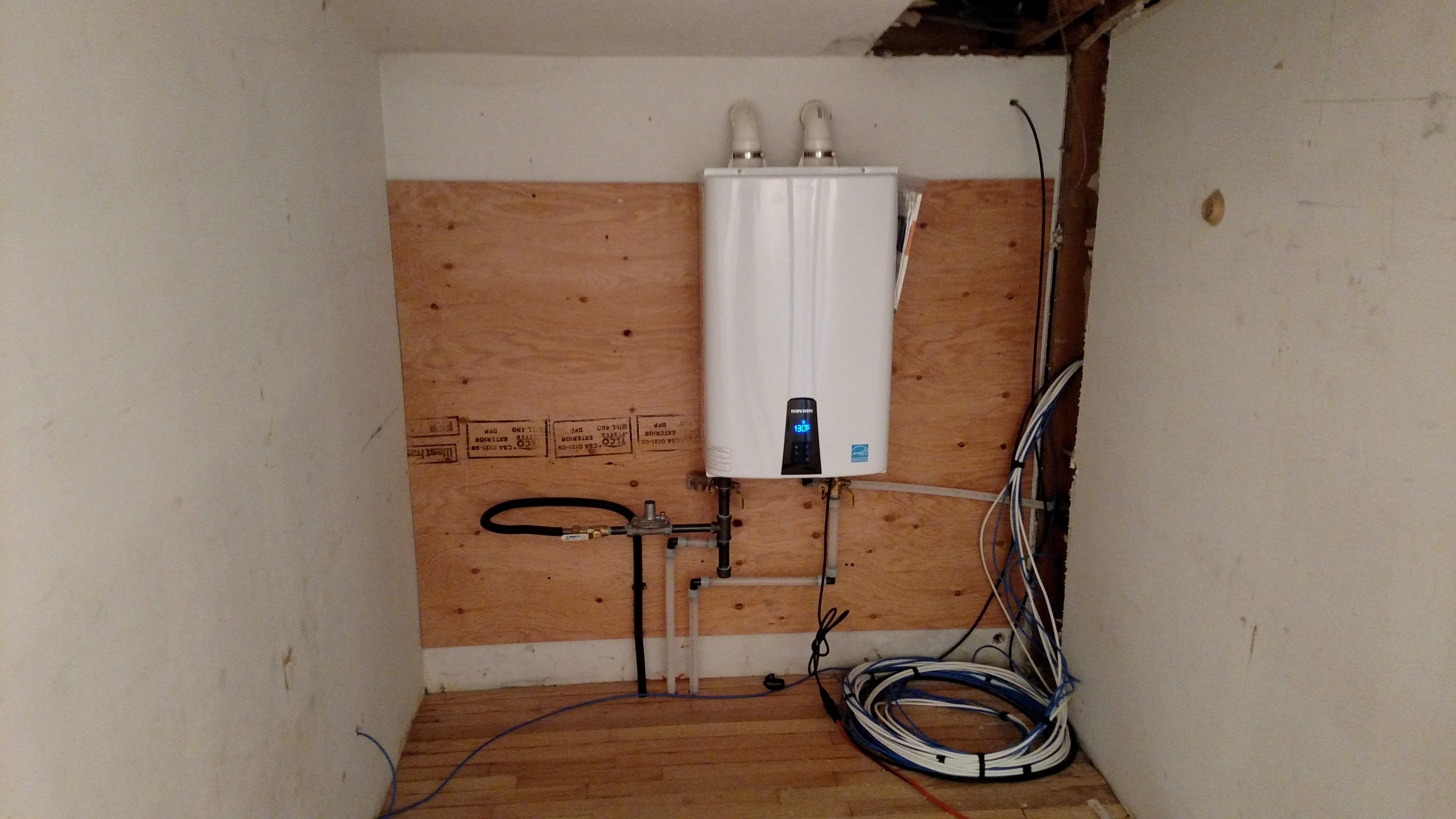 We aren't masters of all crafts, so we got a plumber to do this new instant hot water heater after the old tank heater died right when I arrived home.
